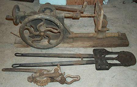 Late 1800's Acme iron drill press, Elgin horn cutters and Woven Wire fence stretcher