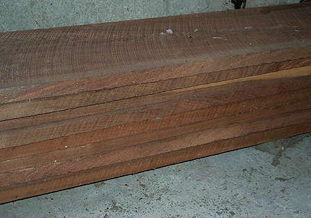Eight 1" x 9" x 11' rough sawn black walnut boards - stored inside