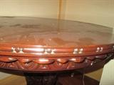 SIDE VIEW OF THIS HIGHLY CARVED ANTIQUE CIRCULAR TABLE WITH CARVED DOLPHINE LEGS