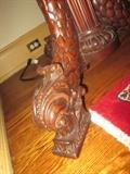 CLOSEUP VIEW OF DOLPHINE LEG ON THIS ANTIQUE MAHOGANY CARVED ROUND TABLE