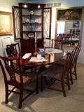 Vintage Baker Pedestal Table with Hepplewhite Chairs in the dining room, a gorgeous Still Life Topped Greek Key Framed Mirror