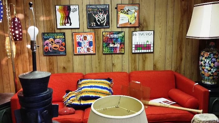 Mid Century modern couch and framed vintage albums.