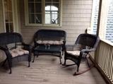 Brown wicker settee, chair, rocker, and coffee table