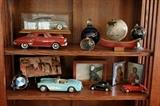 In the entry, open shelving holds an artful display of model cars, art glass, duck decoys and small artwork.