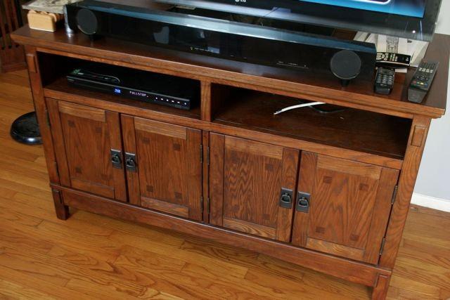 Media cabinet with concealed storage and open shelving.