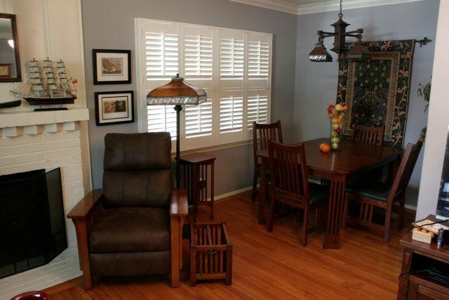 The Craftsman style lounge chair and floor lamp with stained glass and mica shade make a cozy reading spot . A handsome dining table with slat detailed legs and seating for four, measuring 42 x 60 inches.