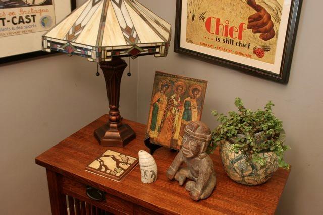 Tabletop vignette with Craftsman style lighting and artful objects.