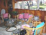 Rattan furniture, round glass top table, vintage telephone (wired to work), etc.