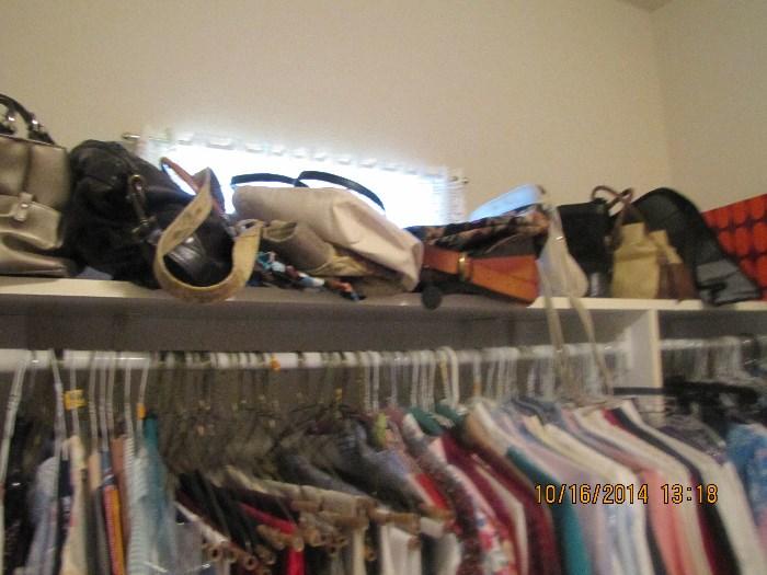 Lots of mens and womens clothes and purses