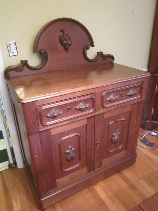 Victorian walnut sideboard with fruit pulls and fruit carving on back splash.