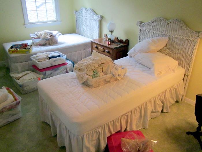 Pair of twin wicker beds, Victorian chest & containers of linens & crochet.