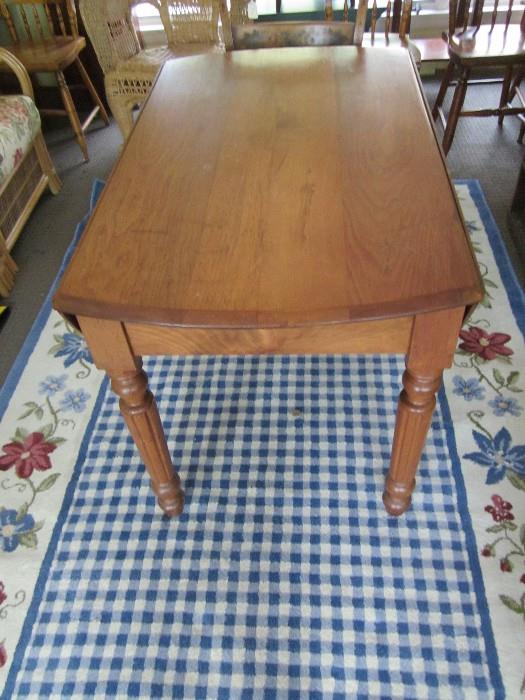 Antique walnut drop leaf table & area rug.