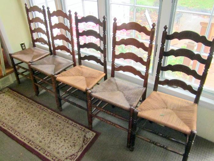 Set of vintage ladder back rush seat chairs.