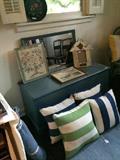     Blue painted blanket chest; decorative pillows; blue wicker chair;