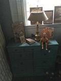 One of several pieces of light blue painted furniture;