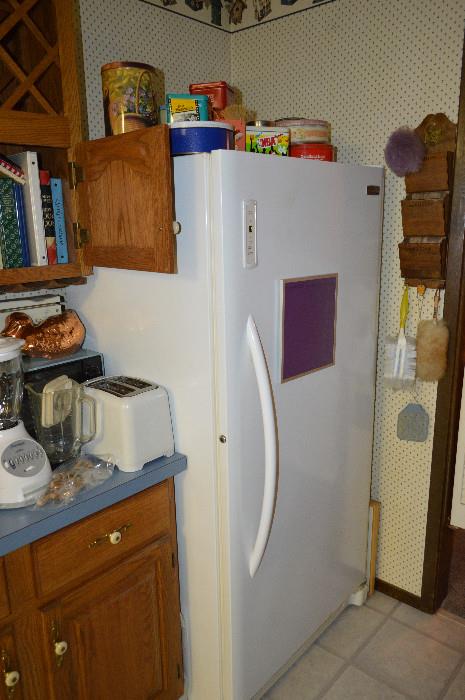 upright deep freeze in kitchen well kept