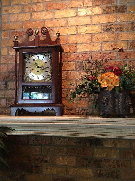               Mantel clock and floral arrangement