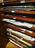 Wood file shelving filled with watercolor art unframed
