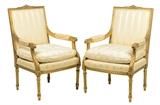 LOT 12: A PAIR OF FRENCH LOUIS XVI STYLE UPHOLSTERED GILTWOOD FAUTEUILS