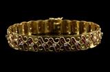 LOT 91: AN 18 KARAT GOLD AND ENAMEL BRACELET