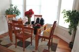 Table with 4 chairs and modern rug