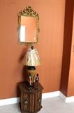 End table, wicker lamp, and gold mirror