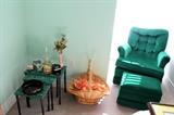 Nesting tables and green upholstered chair with ottoman