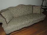 tapestry camelback sofa with wood carved legs, lightly used and clean condition.