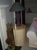 fire place tools and end table with lamp.