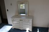 White bedroom set includes dresser highboy, chair and side table.