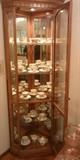 Corner cabinet filled with cups and saucers