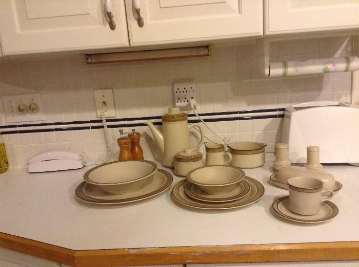Stoneware dishes, teapot, butter, cream and sugar, salt and pepper, mugs, plates, bowls, gravy, etc