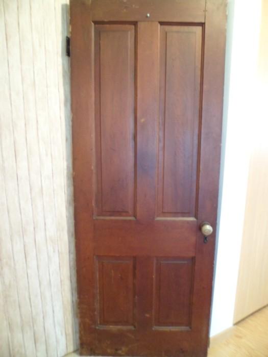 100 year old interior door with brass hinges.