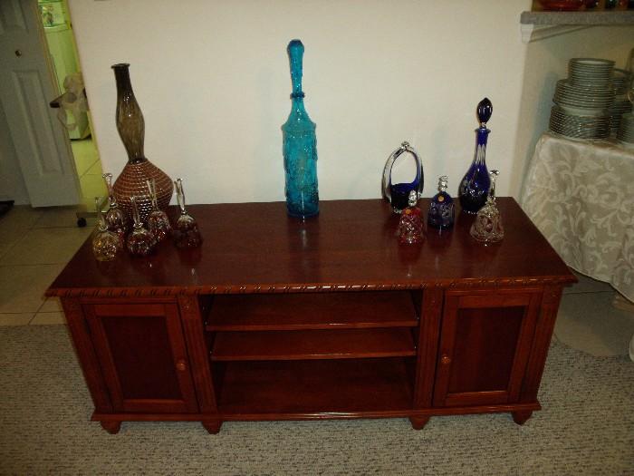 Low media cabinet with glass bells and decanters