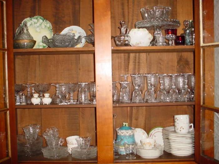 Upper shelves of china cabinet include Fostoria, Limoge, RS Prussia, Fenton, World's Fair ruby glass