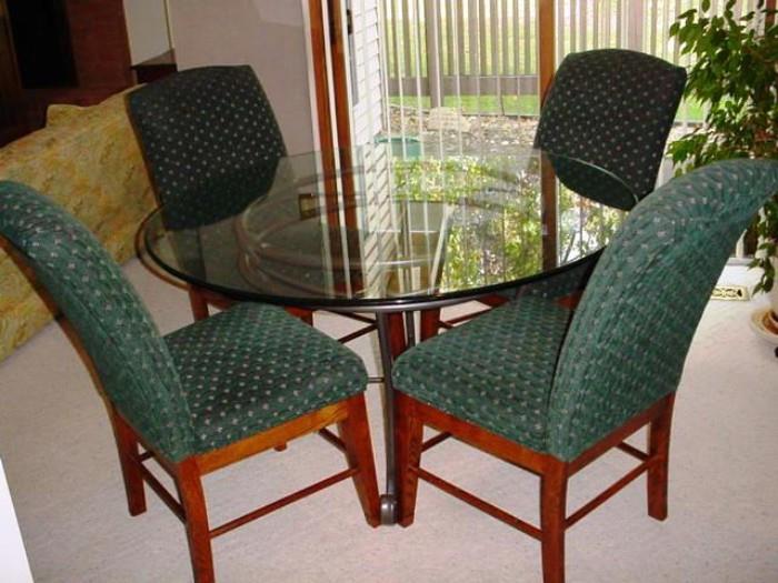 Glass top dining table with four chairs