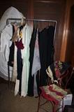 Antique ladies clothing, including a hoop slip hanging in the back