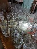 Lots of glassware including Norman Rockwell tumblers, wine glasses, Princess House, glass plates and so much more.