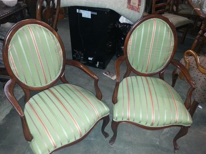 Pair of oval back arm chairs with green striped fabric.  Very nice.