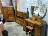 1940's waterfall vanity with round mirror, full size bed, and amoire.
