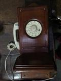 Antique phone that has been adapted with a rotary dial phone
