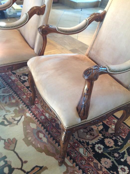 Pair of suede chairs with carved arms and legs