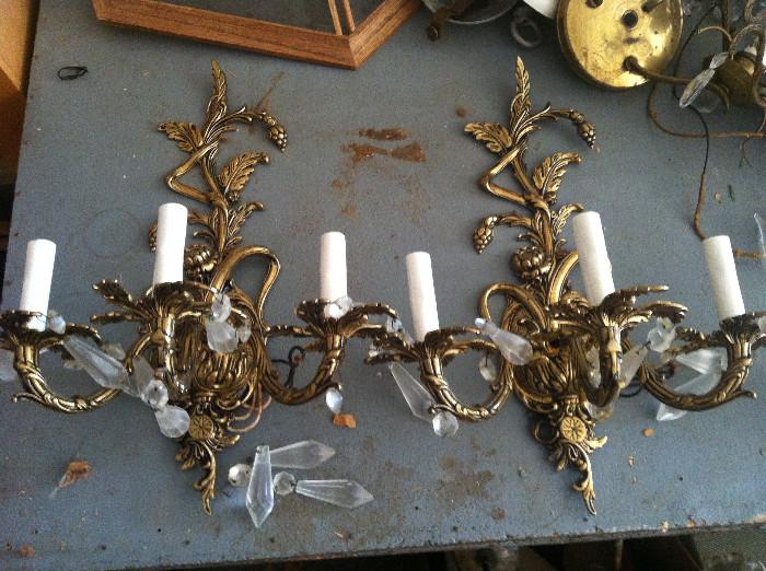 Gilt ornate wall sconces with crystal prisms 