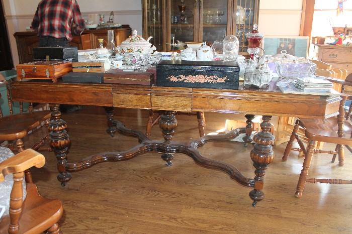 Antique late 19th century dining room table with two modern hand made matching table leaves.