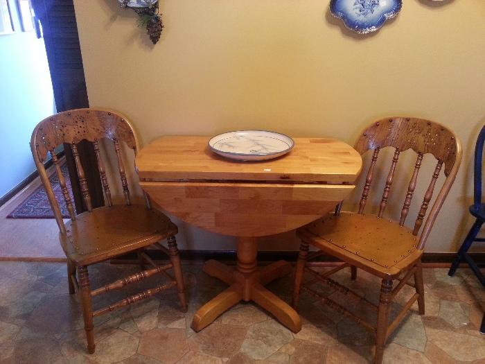 Drop leaf table with antique chairs