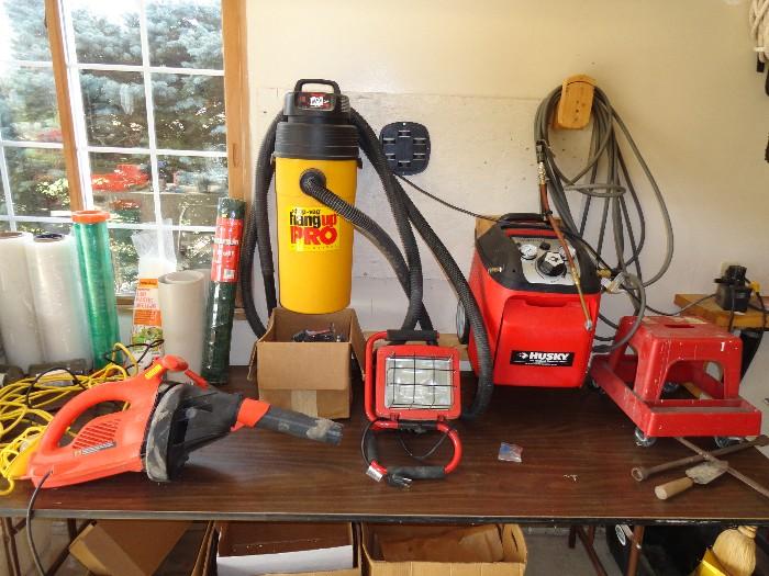 Shop vac and air compressor designed to hang on wall.