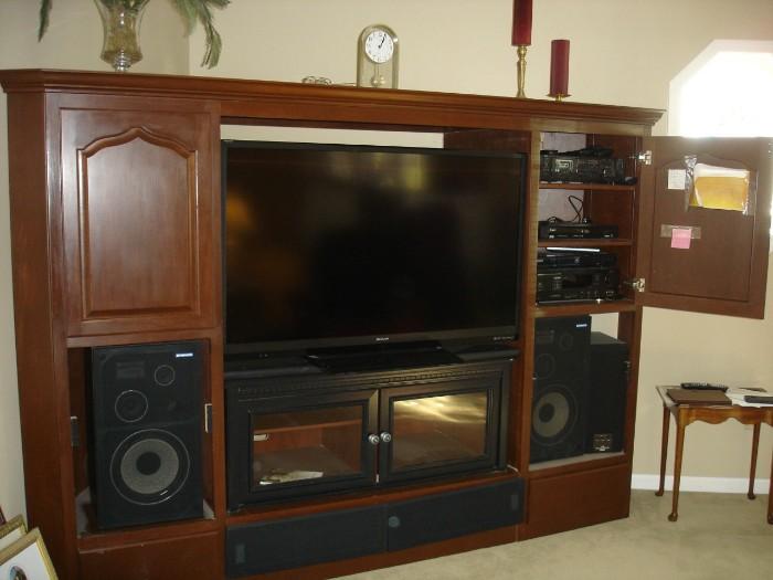 Custom built entertainment center designed to fit in a corner.  Modular in design (5 pieces).....Flat screen not included.