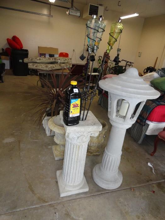 Cement pedestal holding up 3 quality glass Tiki Torches.
