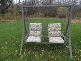 Metal porch swing with cushions.
