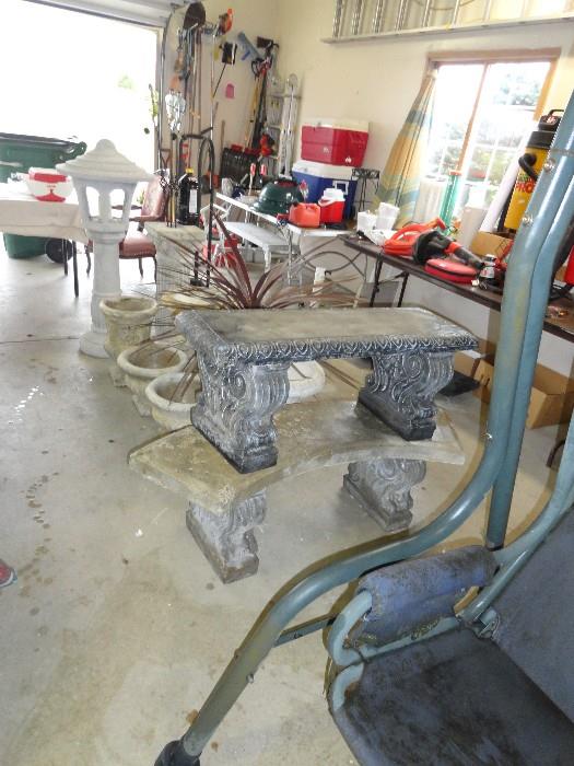 Several cement planters and 2 benches.